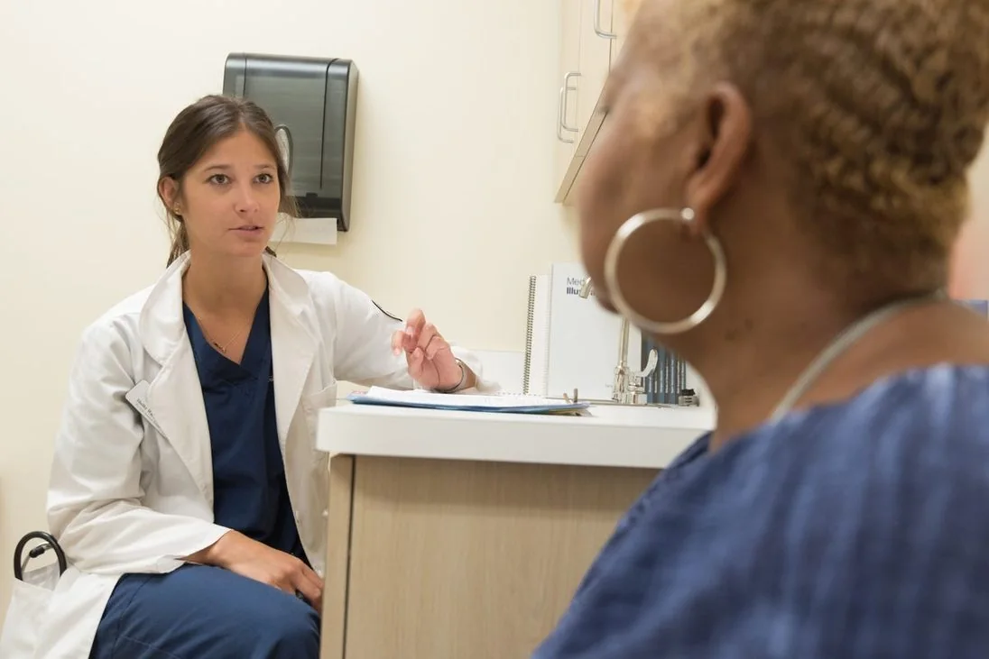 Une médecin en consultation avec une patiente, dans un cabinet clair